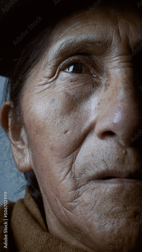 Close-up of an older woman, looking upward, half face composition Close-up of an older woman, looking upward, half face composition