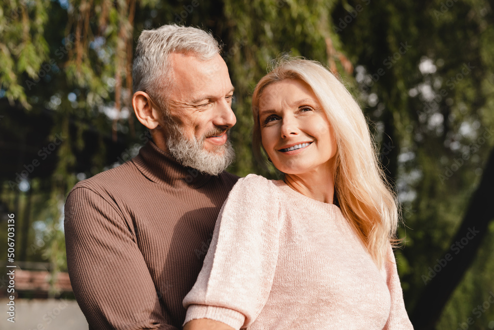 Closeup cropped portrait of a mature loving couple hugging spending time together on a romantic date. Bonding and relationship concept. Closeup cropped portrait of a mature loving couple hugging spending time together on a romantic date. Bonding and relationship concept.