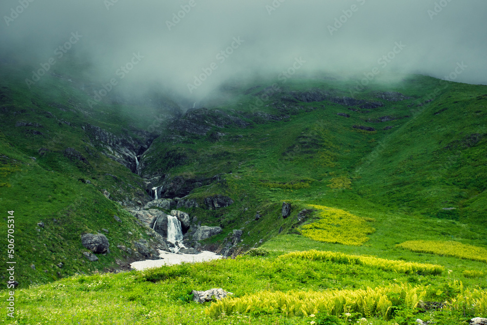 Fototapeta premium Beautiful waterfall in valley of flower, Uttarakhand, India The Valley of Flowers is nestled in the upper expanses of Bhyundar Ganga near Joshimath in Garhwal region.