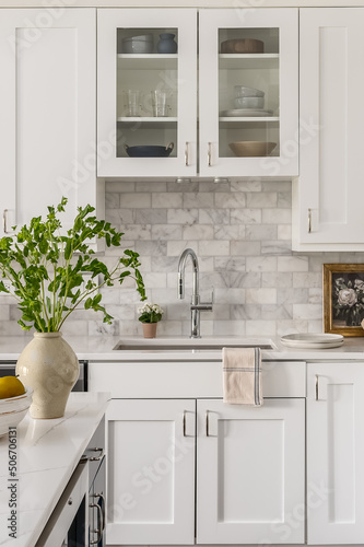 Style Home Still Lifestyle Image. Contemporary Kitchen Design with White Cabinets, Counters, and Backsplash. Interior Design Social Media Banner.