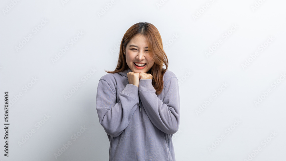 Portrait of beautiful Asian woman doing cheerful pose on isolated yellow background, portrait concept used for advertisement and signage, isolated over white background, copy space. Portrait of beautiful Asian woman doing cheerful pose on isolated yellow background, portrait concept used for advertisement and signage, isolated over white background, copy space.