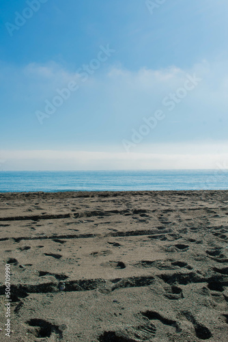 Horizontal lines of the beach, the sea and the calm sky, in vertical plane