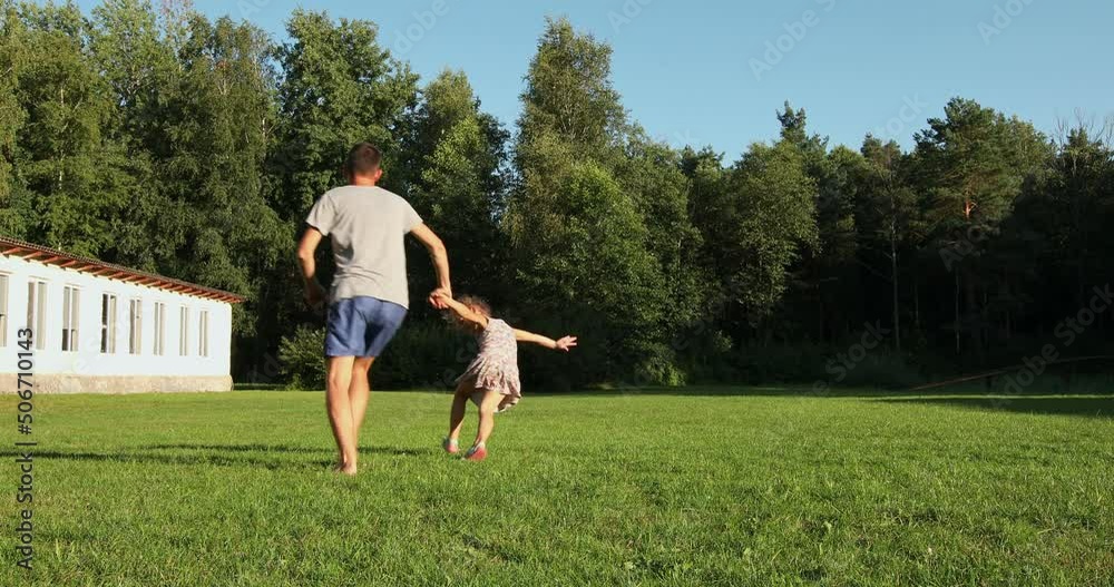Happy family run in park at sunset.