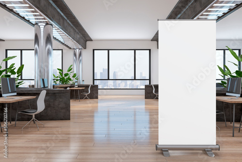 Blank poster on wooden floor in office with modern interior design: metallic columns and dark stone partitions between comfortable work places with city view from big windows. 3D rendering, mockup