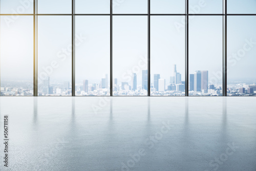Front view on sunny spacious empty hall with city skyline view from huge window and glossy concrete floor with place for presentation of your goods. 3D rendering  mock up