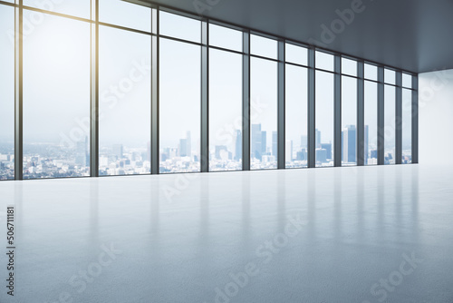 Perspective view on sunny spacious empty hall with sunny city view from glass wall and blank glossy concrete floor. 3D rendering  mock up