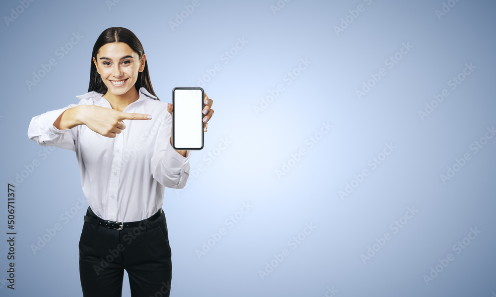 Mobile application concept with happy girl in white shirt showing modern cellphone with white blank screen on abstract blue background with place for your logo or text, mockup Mobile application concept with happy girl in white shirt showing modern cellphone with white blank screen on abstract blue background with place for your logo or text, mockup