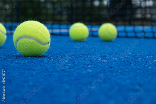 five balls on a paddle tennis court, selective focus, © VicVaz