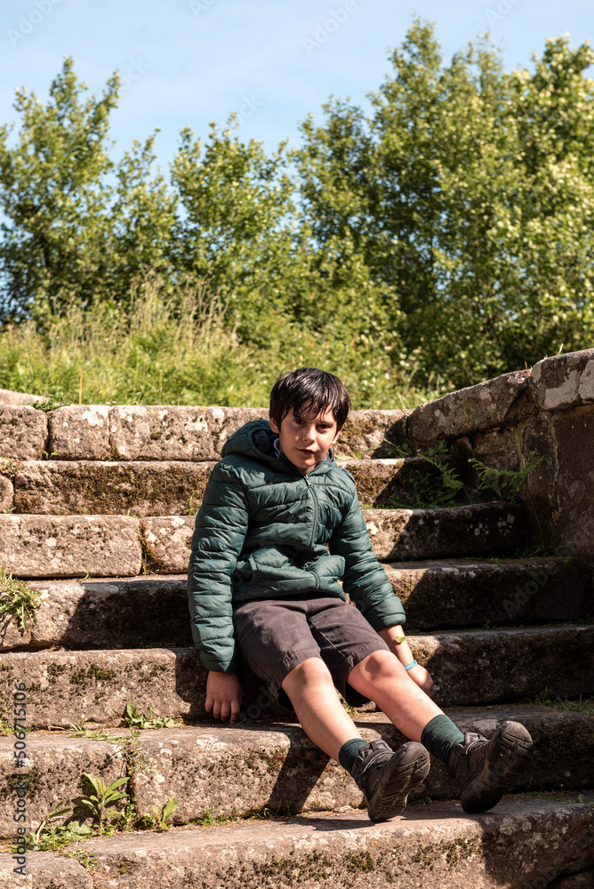 little boy sitting on a stone staircase little boy sitting on a stone staircase