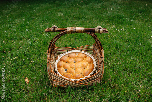 Traditional homemade Czech pastry from yeast dough.Mini cakes stuffed with sweet cream cheese and plum jam in rustic basket.Czech cuisine,picnic scene.Delicious pie ready to eat.Sweet buns photo