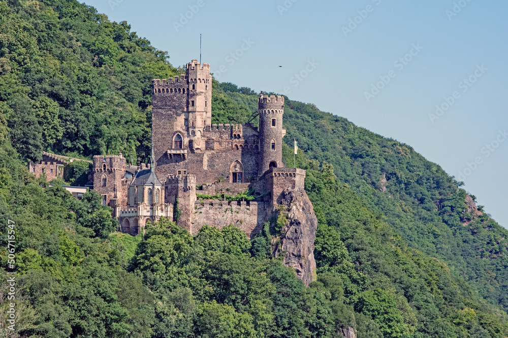 The 14th century Rheinstein Castle perched in steep hills along the Rhine River in Germany.