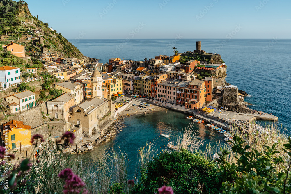 Aerial view of Vernazza and coastline of Cinque Terre,Italy.UNESCO Heritage Site.Picturesque colorful village on rock above sea.Summer holiday,travel background.Italian Riviera landscape.Steep cliff