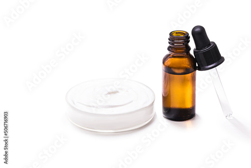 dropper bottle with mandelic acid, acid used to control acne and face oiliness, and fail cream, with copy space and isolated white background