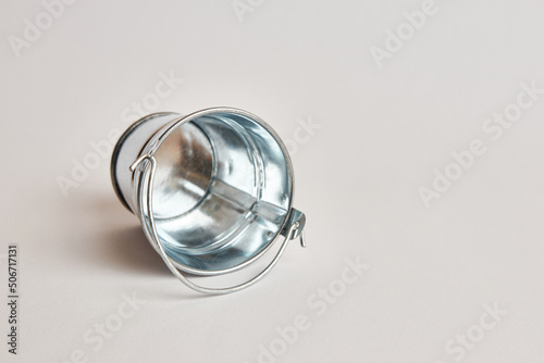 Miniature metal bucket on a white background.