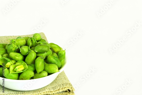 fresh green chickpeas pod in bowl isolated on white background with copy space 