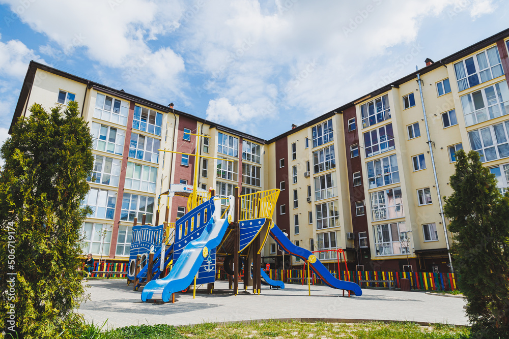 New residential high-rise buildings. Apartments with balconies in a new area. Modern residential buildings. Children's playground in the courtyard of a residential building.