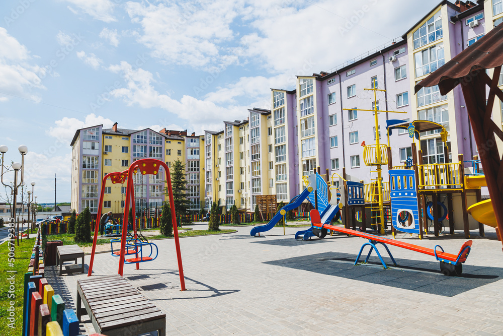 New residential high-rise buildings. Apartments with balconies in a new area. Modern residential buildings. Children's playground in the courtyard of a residential building.