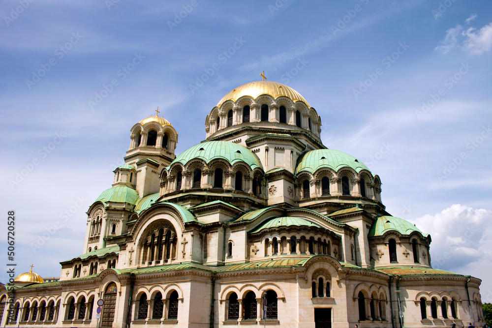 Exterior of the Alexander Nevsky cathedral in the center of Sofia, capital city of Bulgaria, on a sunny day and blue sky for a tourist report - beautiful orthodox symbol for a travel around balkans