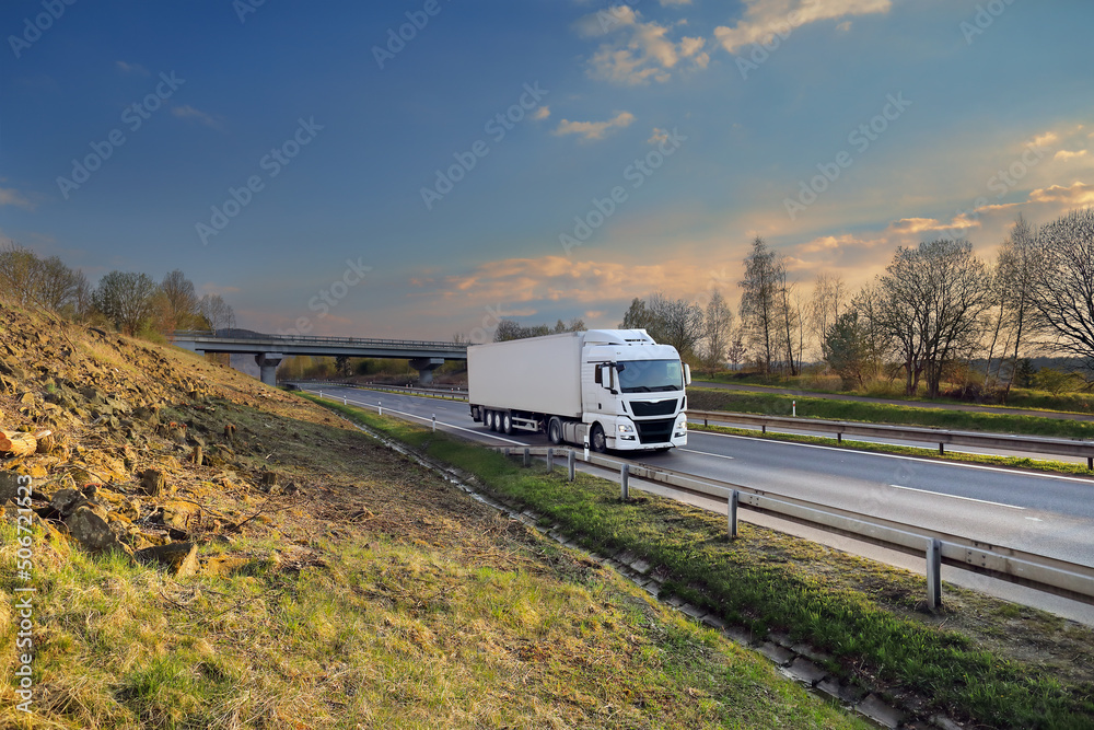 Landscape with a moving truck at sunset 