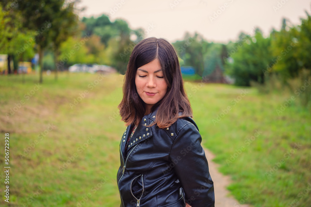 portrait of a smiling young girl with closed eyes in a black jacket portrait of a smiling young girl with closed eyes in a black jacket