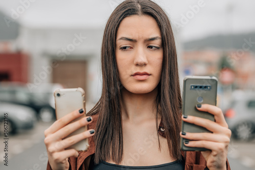 distrustful girl looking at mobile phone photo