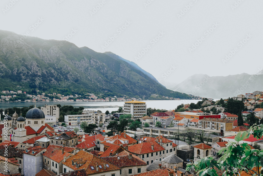 View of the city of Kotor from the mountain Ladder of Kotor, San Giovanni castle view. Mountains sea and bay. Brown rooftops of the city