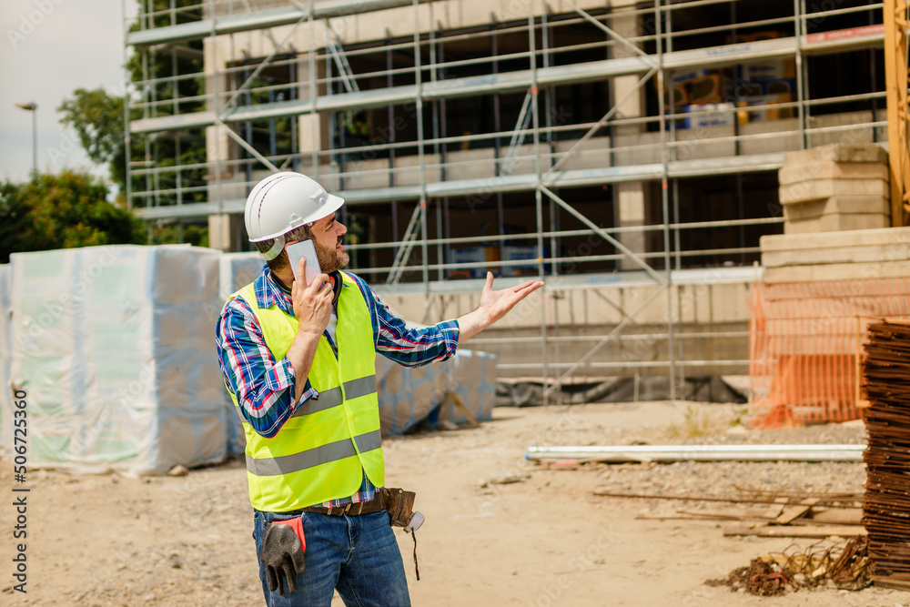 Supervisor talking on the phone on construction site Supervisor talking on the phone on construction site