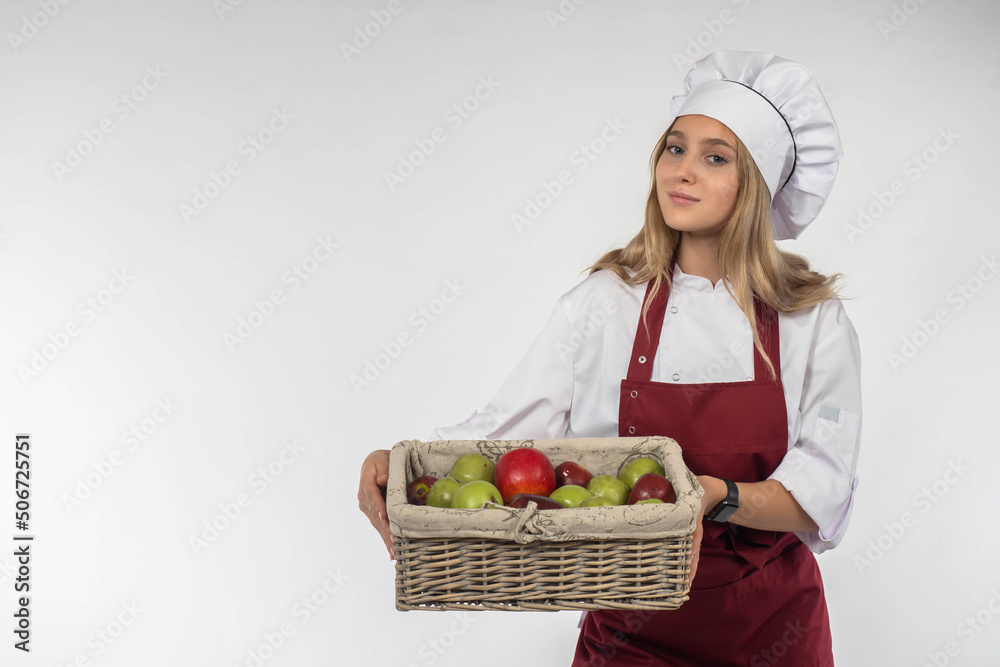Healthy food. Healthy lifestyle concept. Fruit in the hands of the cook. Girl is holding a fruit basket. Vitamins in food. Sale of fresh fruit. Fruit deliveries. Isolated on white. Space for the text Healthy food. Healthy lifestyle concept. Fruit in the hands of the cook. Girl is holding a fruit basket. Vitamins in food. Sale of fresh fruit. Fruit deliveries. Isolated on white. Space for the text