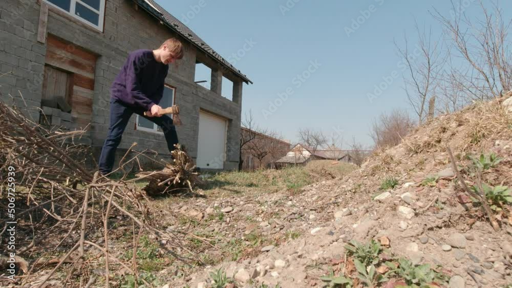 Man in the backyard chopping wood slow motion outdoors Man in the backyard chopping wood slow motion outdoors