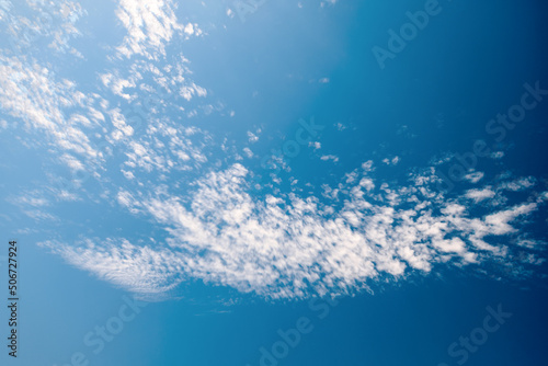  White clouds in the blue sky. Light, cirrus, weightless, melting clouds in the sky on a sunny day.