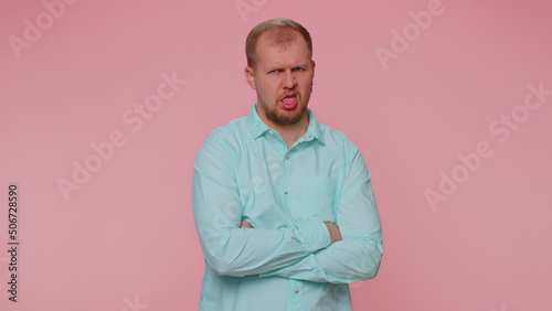 Dissatisfied man shaking head no, asking reason of failure, expressing disbelief irritation, feeling bored, disappointed in result, bad news. Adult guy isolated alone on pink studio wall background