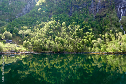 Geirangerfjord. Spring in the norwegian fjords. Reflections. Fishing. Waterfalls. Trees. Boats. Light and clouds. 