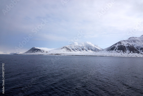 Svalbard. Snow in late spring. Midnight sun. Snowmobiles and Boats. Sun and clouds. Glaciers. North Pole. Ice and Iceberg. Ice caves. Reindeers. Norway.