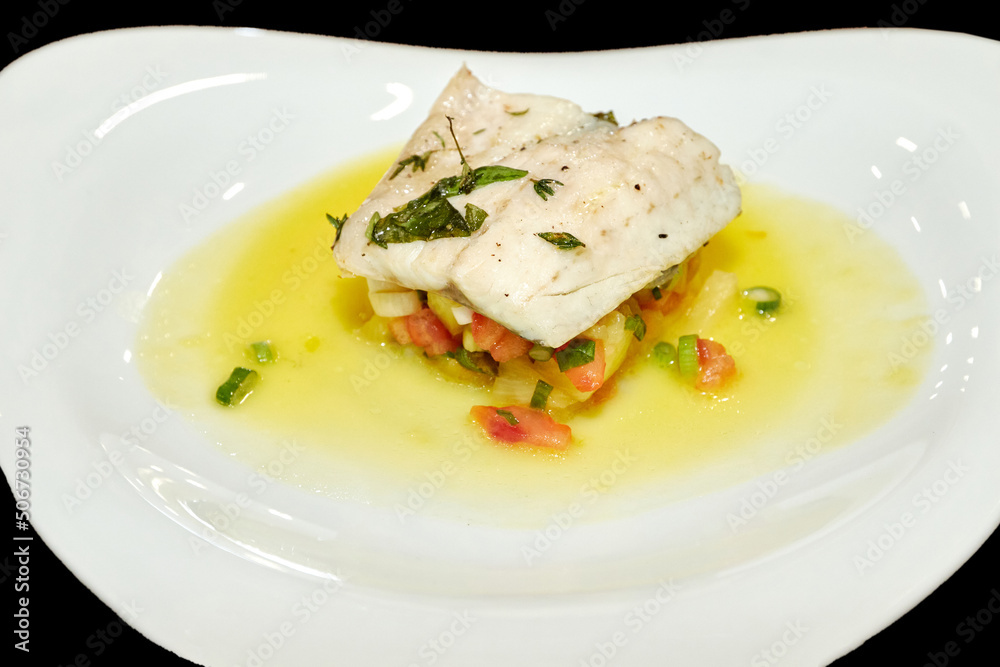 Fish fillet with vegetables and sauce. Fish dish in a restaurant Fish fillet with vegetables and sauce. Fish dish in a restaurant