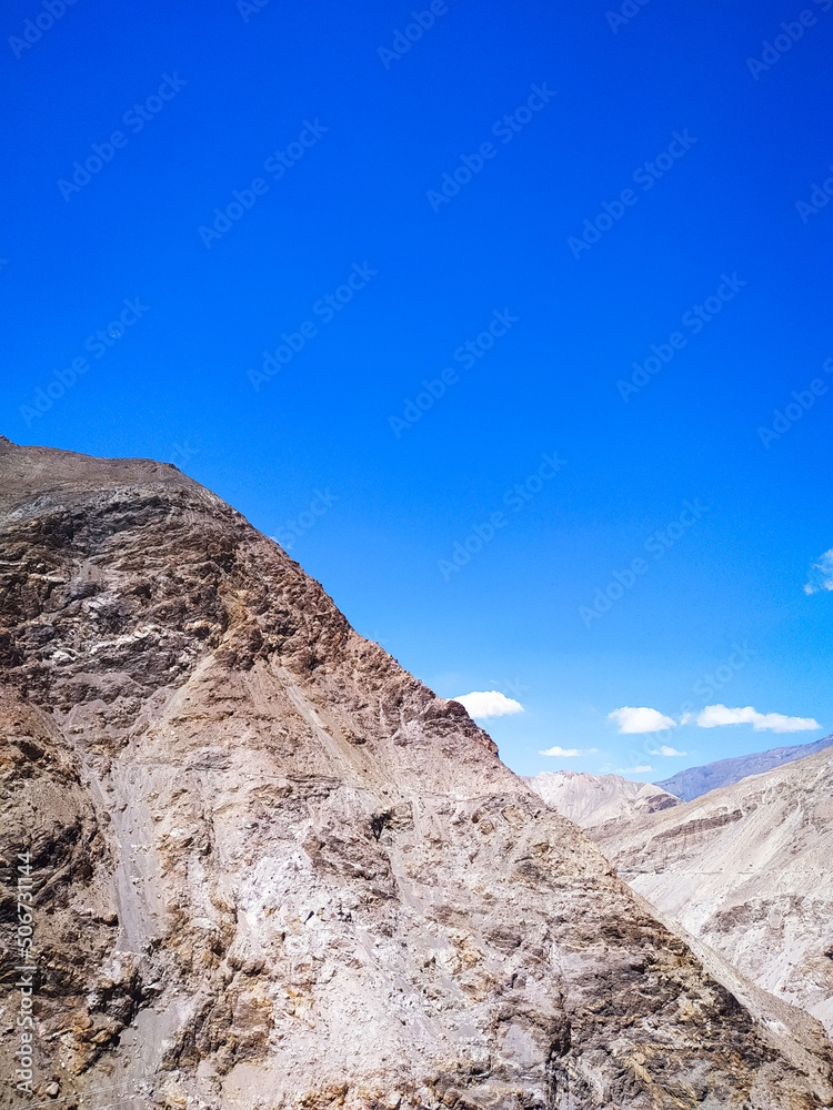 Sand mountain with blue sky and clouds