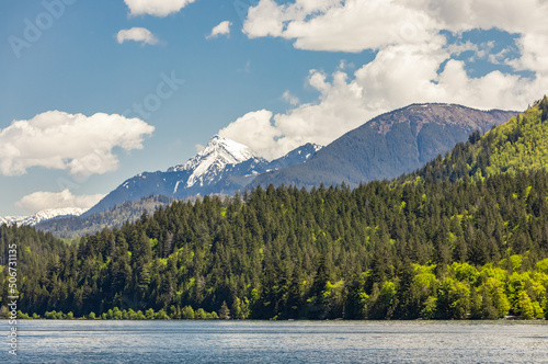 View of a beautiful lake with mountains in the background in sunny summer day