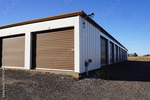 Storage unit buildings sit outside holding the owner's property. © Aaron