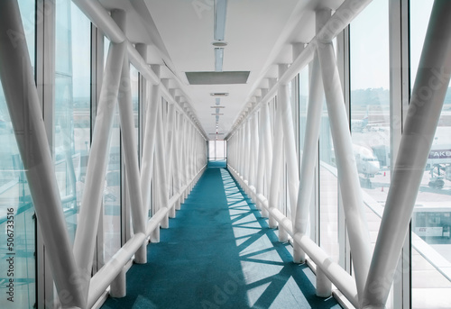 Airport Tunnel. Airplane bridge. Walking down the corridor walkway to aircraft. 