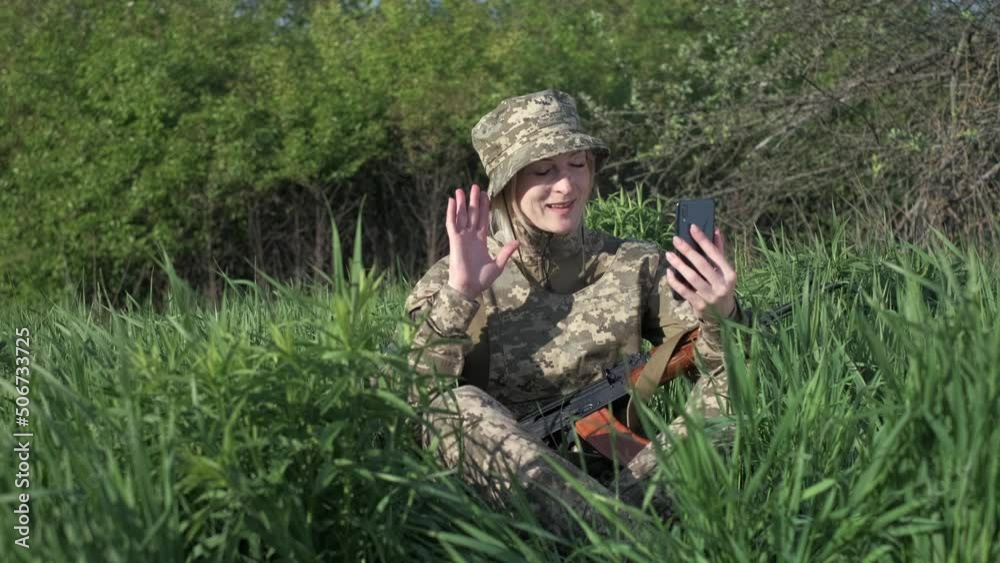 Young Ukrainian female soldier in camouflage uniform with an assault ...