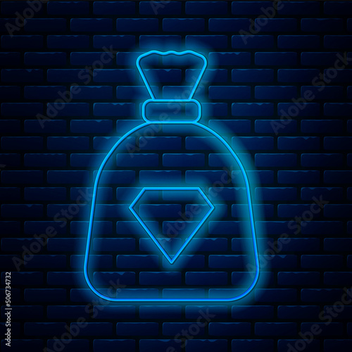 Glowing neon line Bag with gems icon isolated on brick wall background. Vector