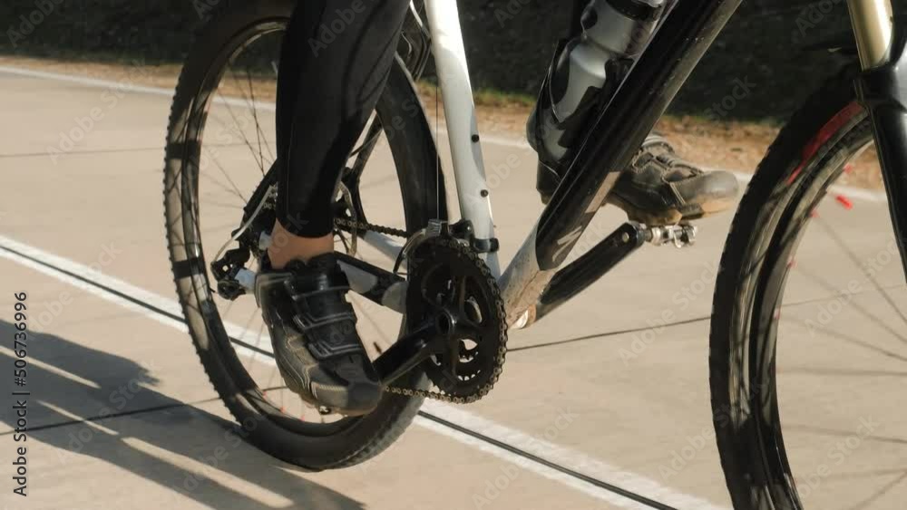 close-up. cyclist rides on the road on a sunny day