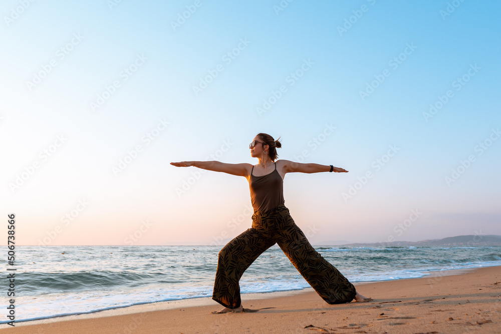 Beautiful woman doing yoga on the beach with copy space Beautiful woman doing yoga on the beach with copy space