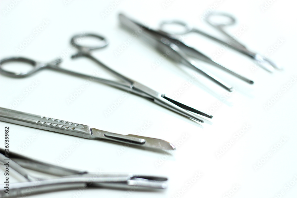 Surgical instruments isolated on the white background, focus on the scalpel blade Surgical instruments isolated on the white background, focus on the scalpel blade