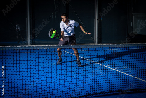 Obraz na plátně Man playing padel tennis indoor