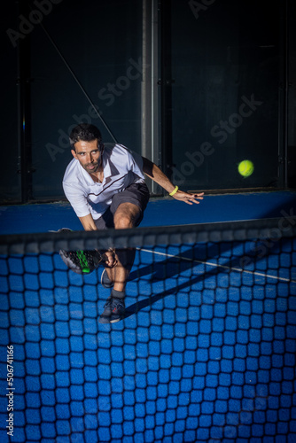 Man playing padel tennis indoor