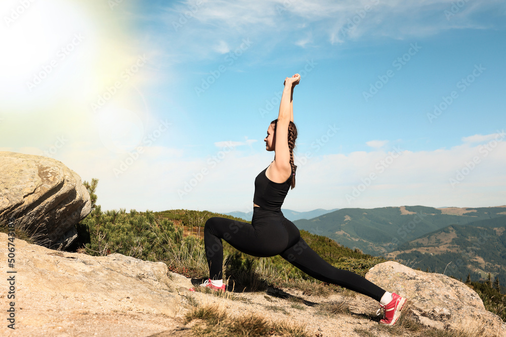Beautiful young woman practicing yoga in mountains on sunny morning Beautiful young woman practicing yoga in mountains on sunny morning