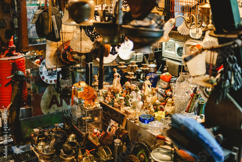 antiques in the vintage shop: art, toy cars, lantern lamps, sculpture, miniatures, old cameras, televisions, typewriter, etc. Kota Lama Semarang (Old Town), Indonesia antique store. photo