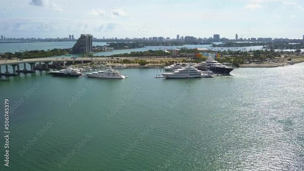 Aerial view towards big, expensive yachts, in sunny Island Gardens, Miami, USA - approaching, drone shot Aerial view towards big, expensive yachts, in sunny Island Gardens, Miami, USA - approaching, drone shot