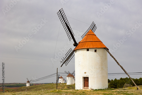 Scenic spring landscape of Mota del Cuervo with main attraction of La Mancha - ancient windmills closely associated with Don Quixote, Spain