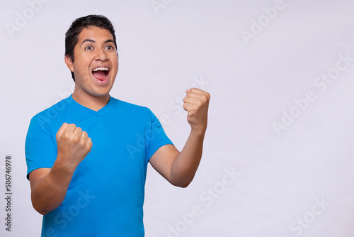 Latino hispanic young man with blue shirt white background
